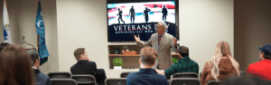 President of Quincy College talks to students at the Veteran Celebration event.