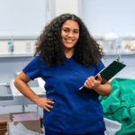 Female Certified Nursing Assistant student holding a clipboard