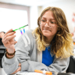 high school student conducting a science experiment