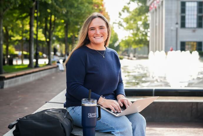 Current student holding a laptop