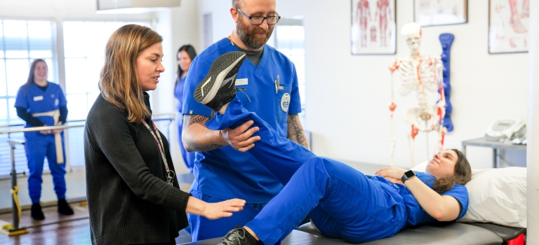 Quincy College's physical therapy assistant programs students working in the PTA lab.