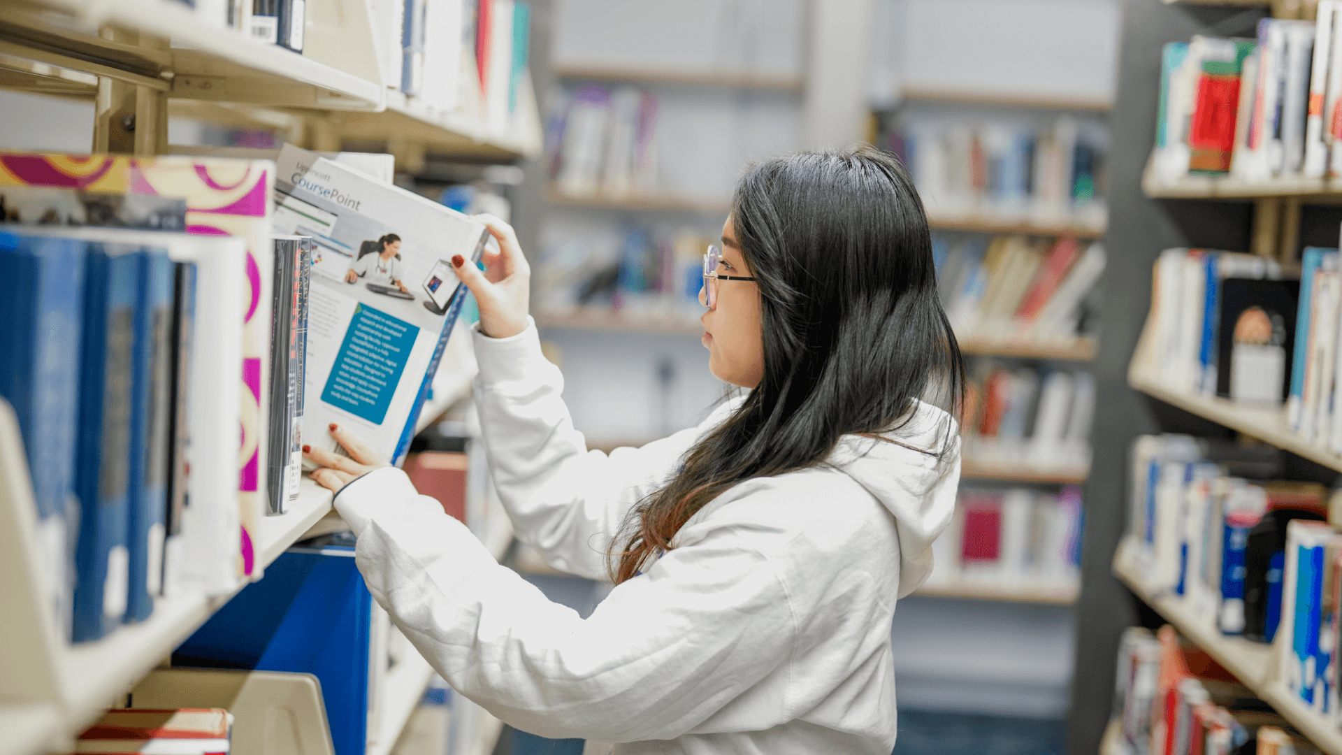 Quincy College student at the library